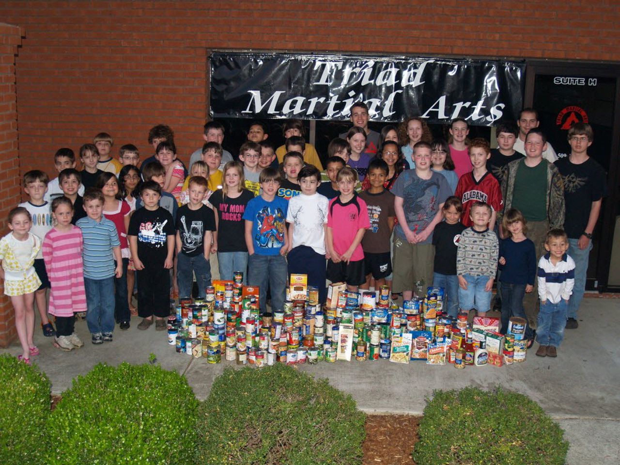 Triad Martial Arts Academy students collect canned food to help the