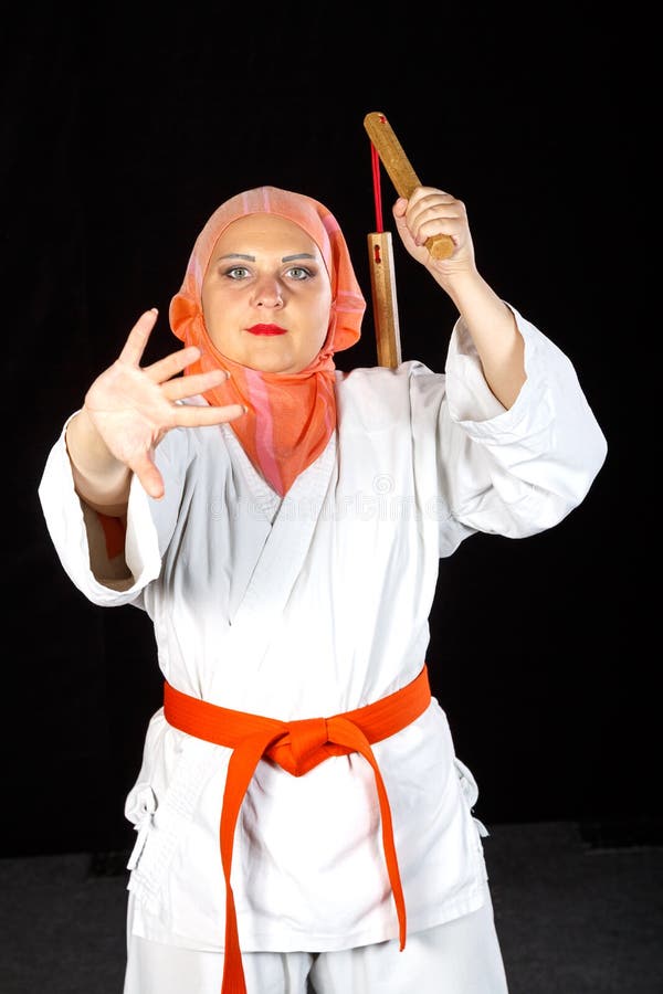 Muslim Woman in Kimono and Hijab in Karate Class is Training with