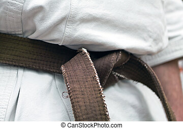 Karate brown belt. Karate brown belt closeup isolated on white background.